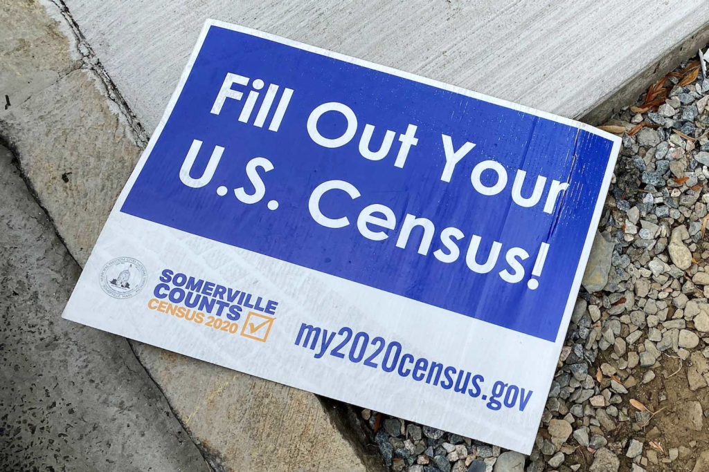 A sign encouraging participation in the U.S. Census lies on a sidewalk in Somerville, Massachusetts, U.S., August 4, 2020. REUTERS/Brian Snyder/File Photo