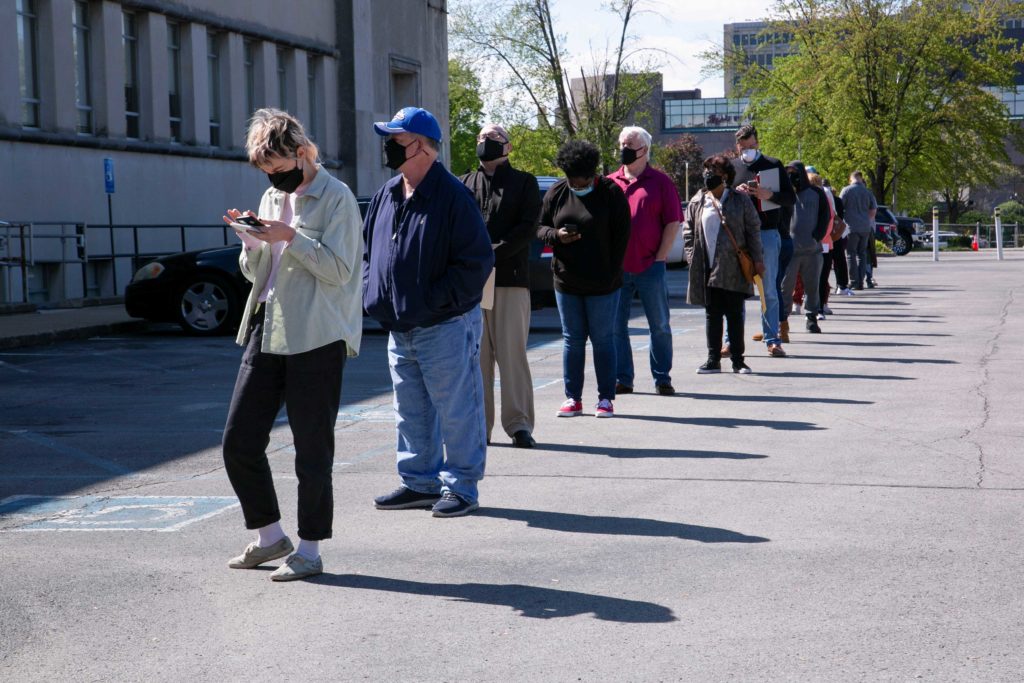 People line up outside a newly reopened career center for in-person appointments in Louisville, U.S., April 15, 2021. REUTERS/Amira Karaoud