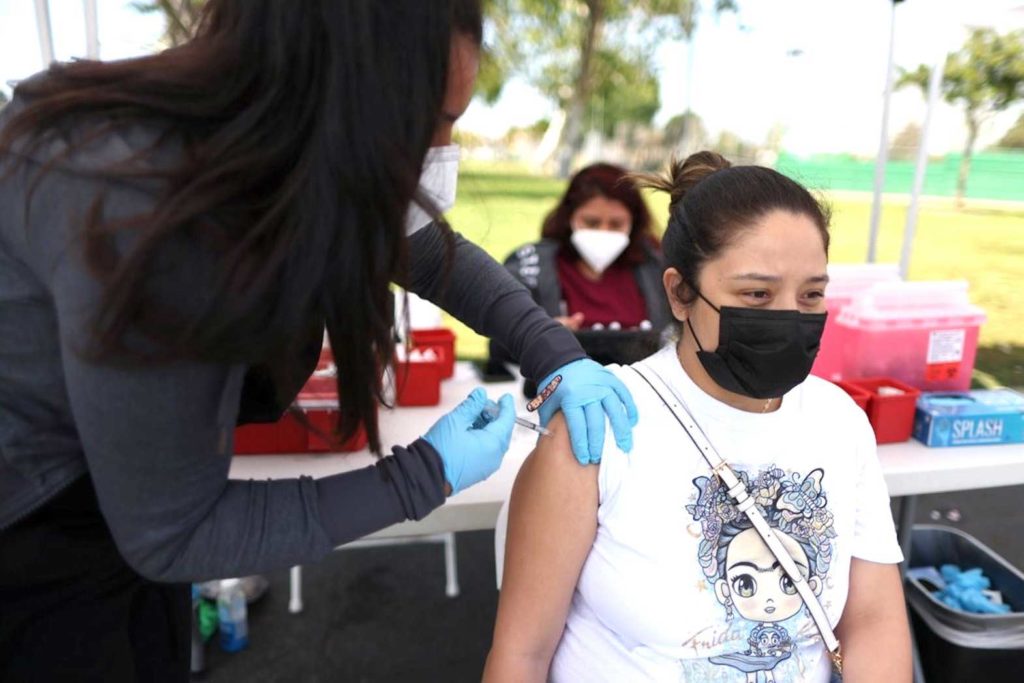 A woman getting vaccinated against Covid-19 in California. REUTERS