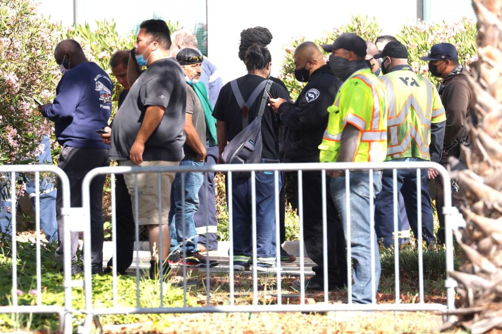 Valley Transportation Authority workers wait outside the Santa Clara Sheriff's offices as police secure the scene of a mass shooting at a rail yard run by the Santa Clara Valley Transportation Authority in San Jose, California, U.S. May 26, 2021. REUTERS/Peter DaSilva