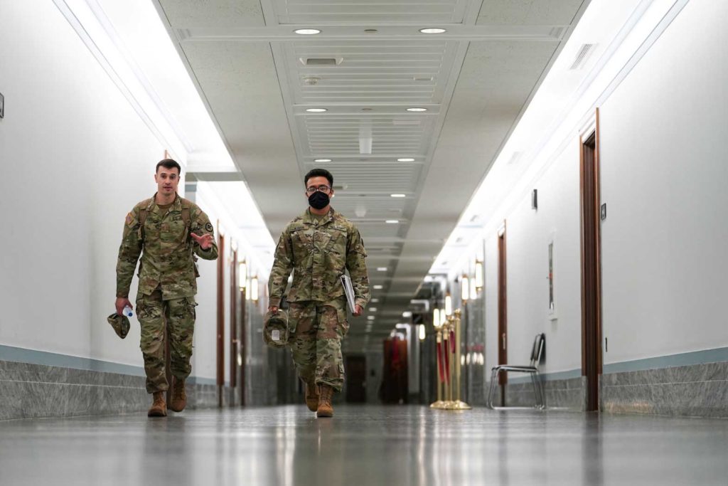   Members of the National Guard walk in the Dirksen Senate Office Building on Capitol Hill on the final days of their deployment following the January 6 Capitol riots in Washington, U.S., May 23, 2021. REUTERS/Sarah Silbiger