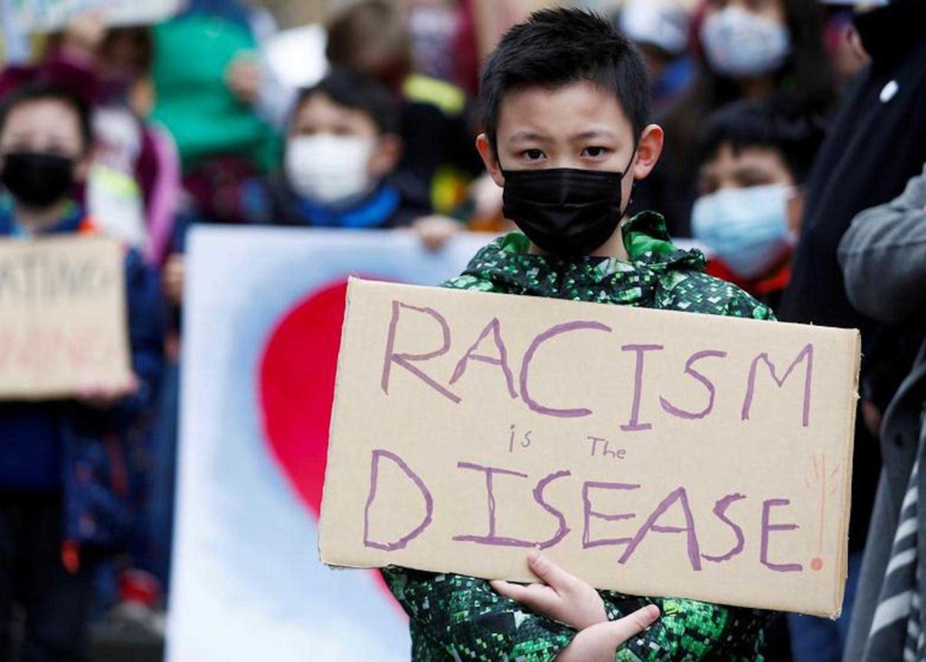  Ethan Yang, 11, holds a sign reading "racism is the disease" during a "Kids vs. Racism" rally against anti-Asian hate crimes at Hing Hay Park in the Chinatown-International District of Seattle, Washington, U.S. March 20, 2021. REUTERS