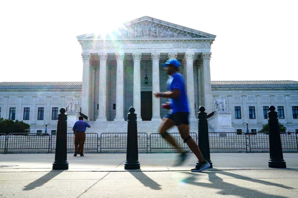People walk past the U.S. Supreme Court the day the court is set to release orders and opinions in Washington, U.S., June 1, 2021. REUTERS/Erin Scott