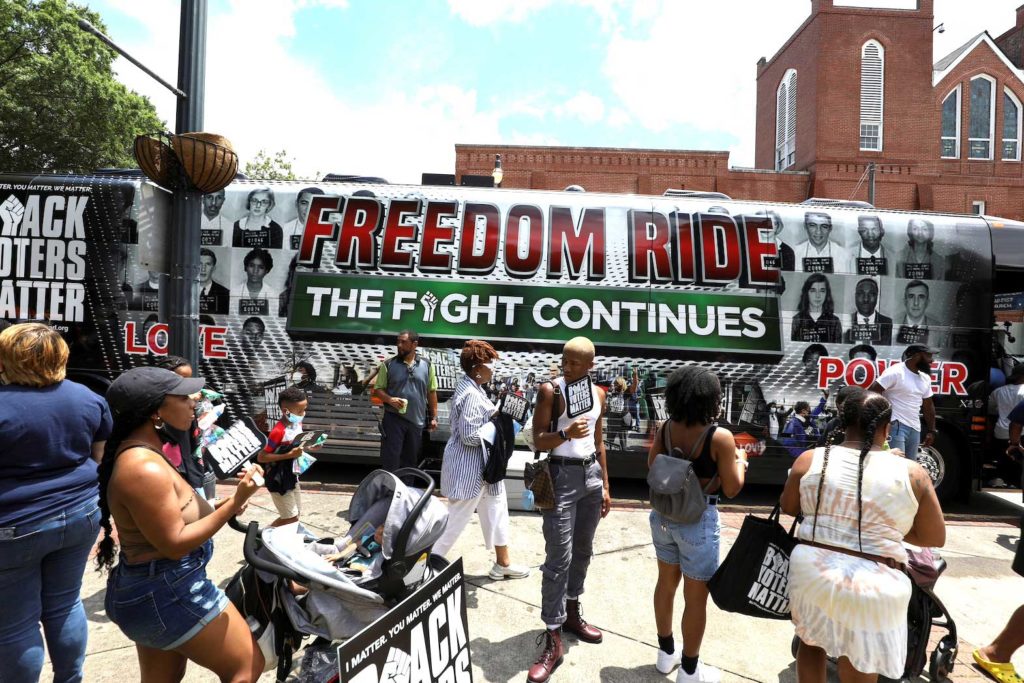  People gather in front of one of the tour buses during a stop on the Freedom Ride For Voting Rights at Ebenezer Baptist Church in Atlanta, Georgia, U.S. June 21, 2021. REUTERS/Dustin Chambers