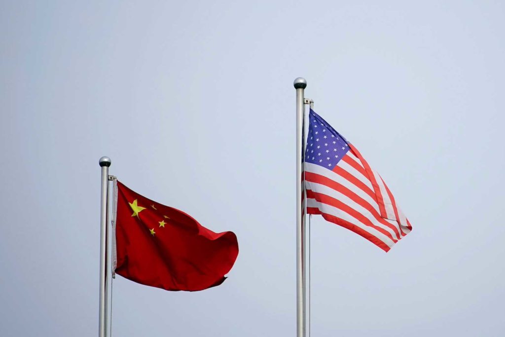 Chinese and U.S. flags flutter outside a company building in Shanghai, China April 14, 2021. REUTERS/Aly Song/File Photo