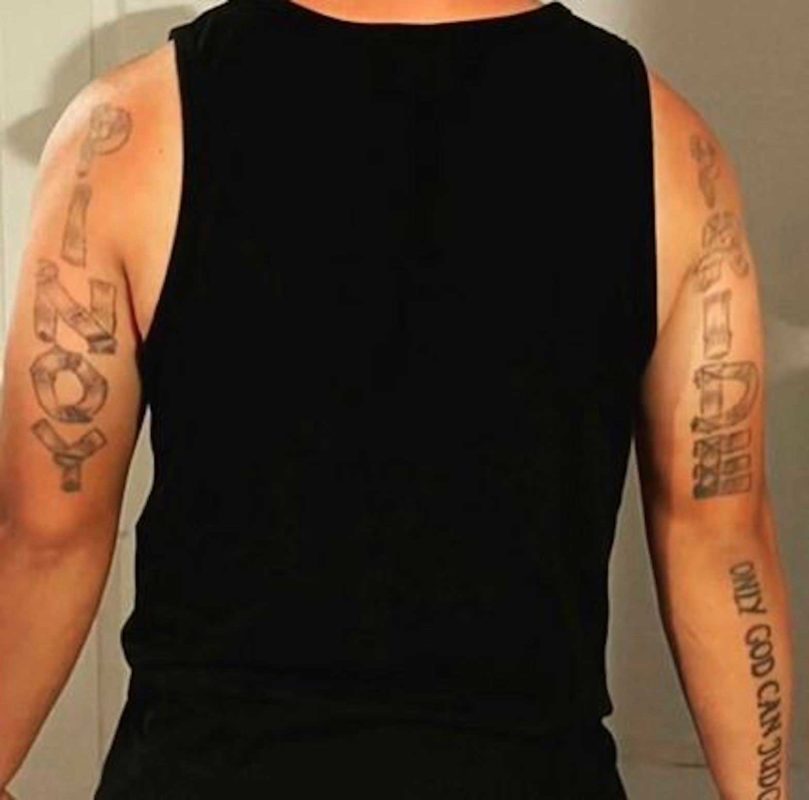 Mark Devera's tattoos read "Pinoy" and "Pride." SCREENSHOT CBS