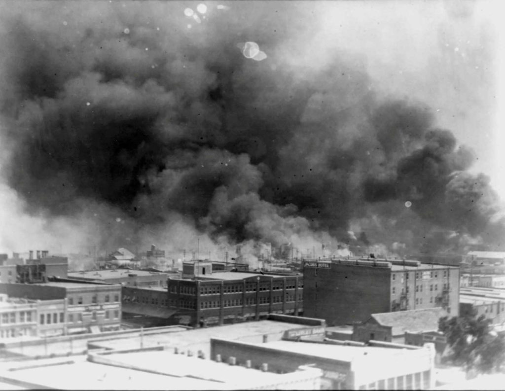 Smoke rises from buildings during the race massacre in Tulsa, Oklahoma, U.S. in 1921. Alvin C. Krupnick Co/NAACP