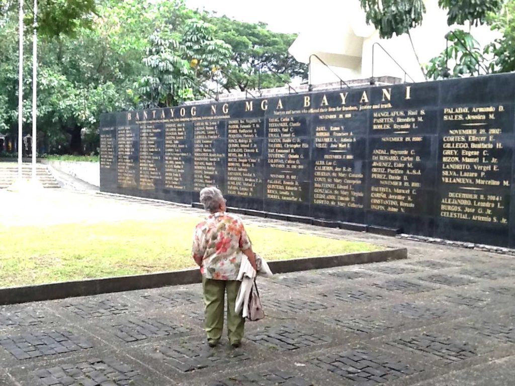 Ade viewing the memorial wall at the Bantayog ng mga Bayani, a Philippine monument to the martyrs and heroes of the anti-dictatorship movement, which includes the names of her son Silme Domingo and Gene Viernes. EDWIN BATONGBACAL