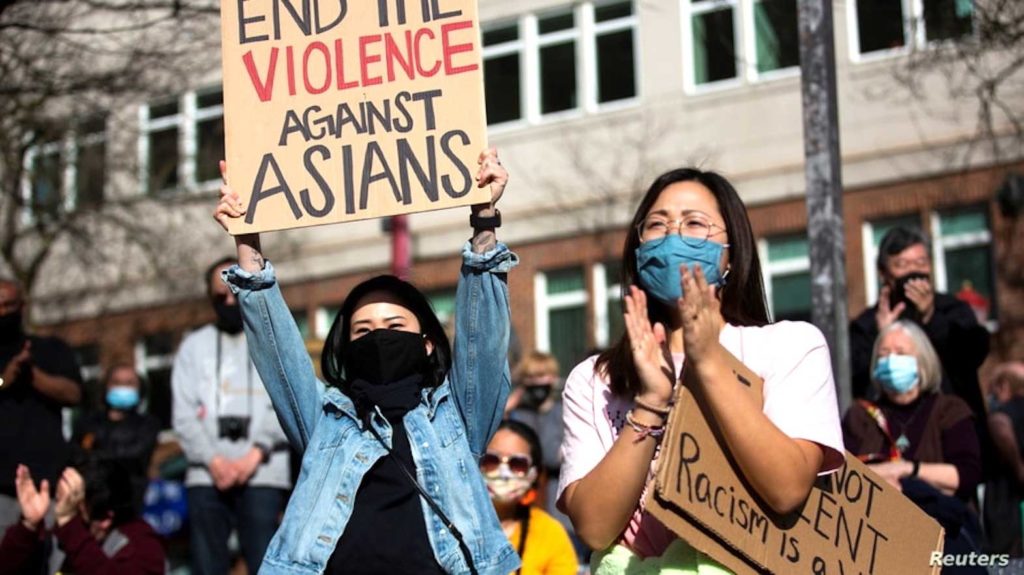Demonstrators cheer while listening to speakers during a protest against anti-Asian hate crimes at Hing Hay Park in the Chinatown-International District of Seattle, Washington, March 13, 2021. REUTERS