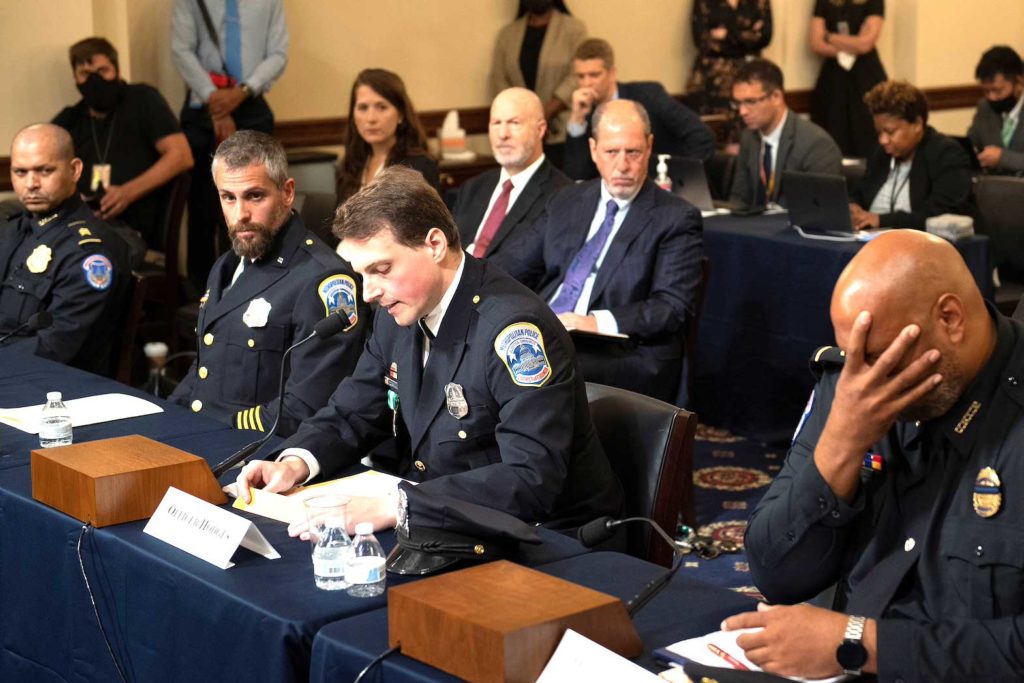 Aquilino Gonell, sergeant of the U.S. Capitol Police, Michael Fanone, officer for the Metropolitan Police Department, and Harry Dunn, private first class of the U.S. Capitol Police, listen while Daniel Hodges, officer for the Metropolitan Police Department, testifies during a hearing of the House select committee investigating the Jan. 6 attack on Capitol Hill in Washington, U.S., July 27, 2021. Brendan Smialowski/Pool via REUTERS