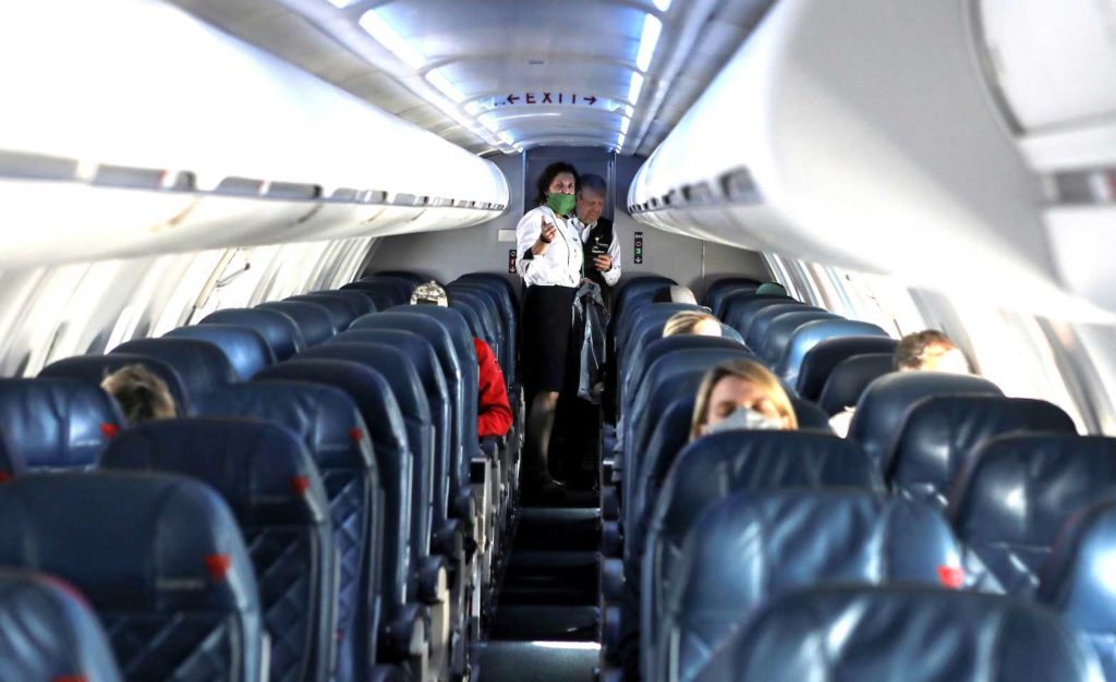 Flight attendants talk in a nearly empty cabin on a Delta Airlines flight operated by SkyWest Airlines as travel has cutback, amid concerns of the coronavirus disease (COVID-19), during a flight departing from Salt Lake City, Utah, U.S. April 11, 2020. REUTERS/Jim Urquhart
