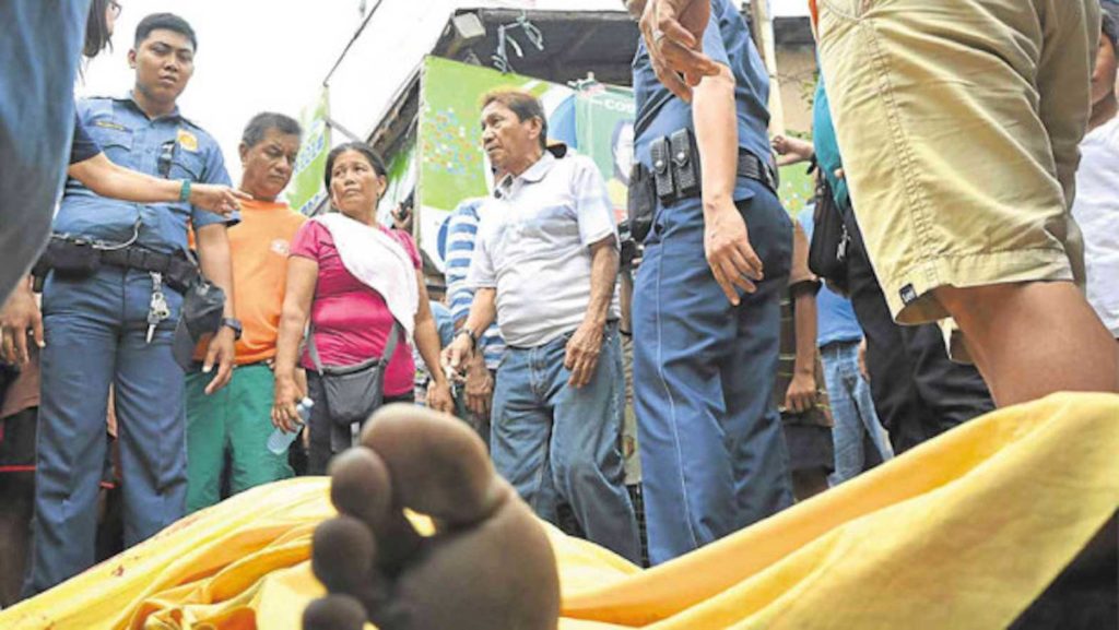 Funeral parlor workers lift the body of one of the two drug suspects who were killed in an alleged shootout with police in Barangay Bonuan Tondaligan in Dagupan City on Monday. RAY B.ZAMBRANO/INQUIRER NL
