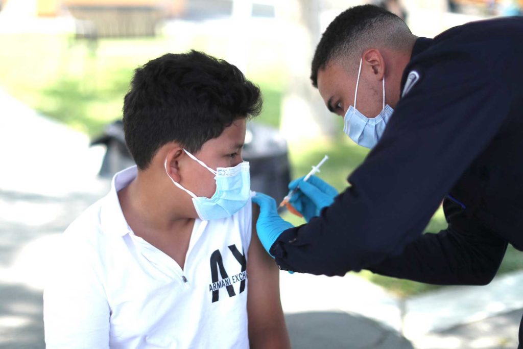Alessandro Roque, 12, receives a coronavirus disease (COVID-19) vaccination as part of a vaccine drive by the Fernandeno Tataviam Band of Mission Indians in Arleta, Los Angeles, California, U.S., August 23, 2021. REUTERS/Lucy Nicholson