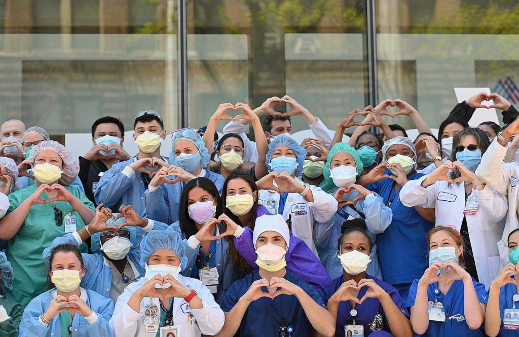 Nurses and health care workers gesturing love in celebration of Nurse Week and International Nurses Day outside Mt Sinai Queens in the Queens borough of New York City. ProPublica reported that at least 30 Filipino health workers had died in the New York-New Jersey region since the end of March. AFP