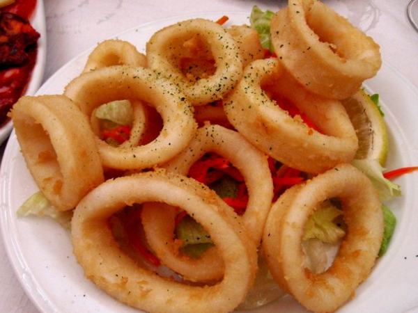 How do you tenderize calamari before frying?