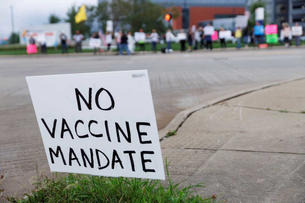  A sign against the coronavirus disease (COVID-19) vaccine mandates is seen in the grass during a protest against coronavirus disease (COVID-19) vaccine mandates at Summa Health Hospital in Akron, Ohio, U.S., August 16, 2021. REUTERS/Stephen Zenner