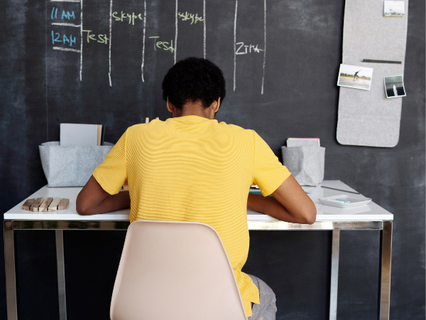 This is a child sitting on a desk.