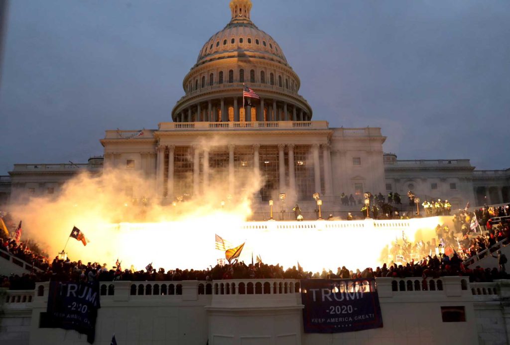 An explosion caused by a police munition is seen while supporters of U.S. President Donald Trump gather in front of the U.S. Capitol Building in Washington, U.S., January 6, 2021. REUTERS/Leah Millis/File Photo/File PhotoD