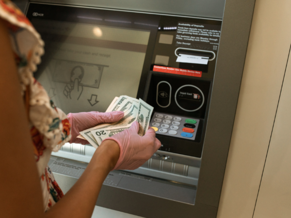 This is a person withdrawing money from an ATM.