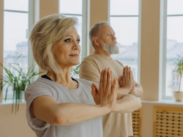 Elderly people performing yoga