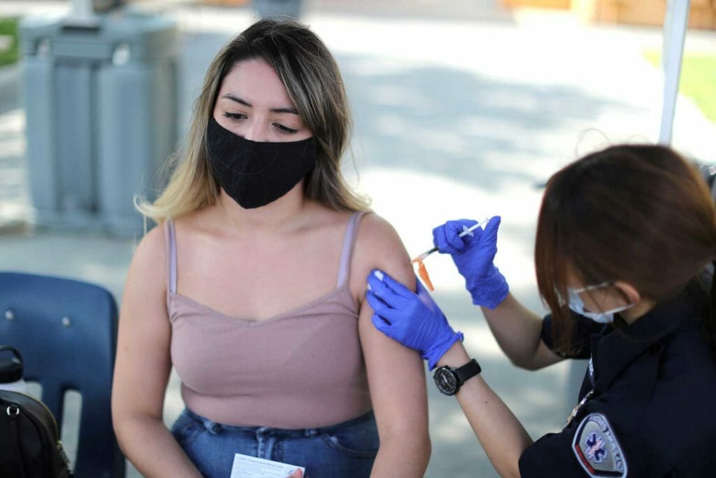  Julissa Vasquez, 23, receives a coronavirus disease (COVID-19) vaccination as part of a vaccine drive by the Fernandeno Tataviam Band of Mission Indians in Arleta, Los Angeles, California, U.S., August 23, 2021. REUTERS/Lucy Nicholson
