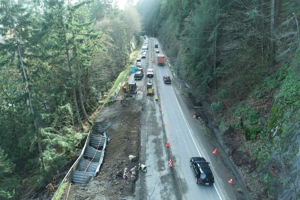 Workers inspect a washed out lane of Trans Canada Highway 1 after devastating rain storms caused flooding and landslides, in Malahat, British Columbia, Canada November 17, 2021. Picture taken November 17, 2021. B.C. Ministry of Transportation and Infrastructure/Handout via REUTERS.