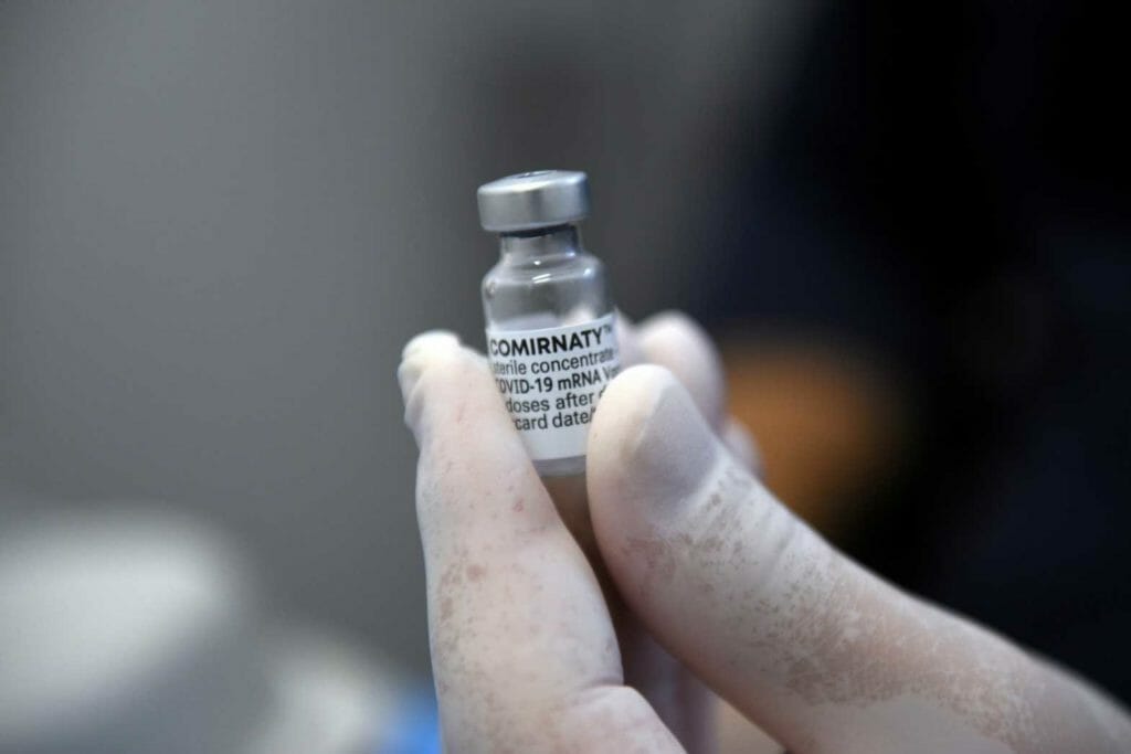 Nurse Gavriil Hadjioannou holds a vial of the Pfizer-BioNTech vaccine against the coronavirus disease (COVID-19) at the health centre of Karyes, the administrative centre of the all-male Orthodox monastic community of Mount Athos, Greece, November 16, 2021. REUTERS/Alexandros Avramidis