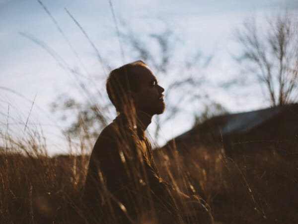 This is a person meditating outdoors.