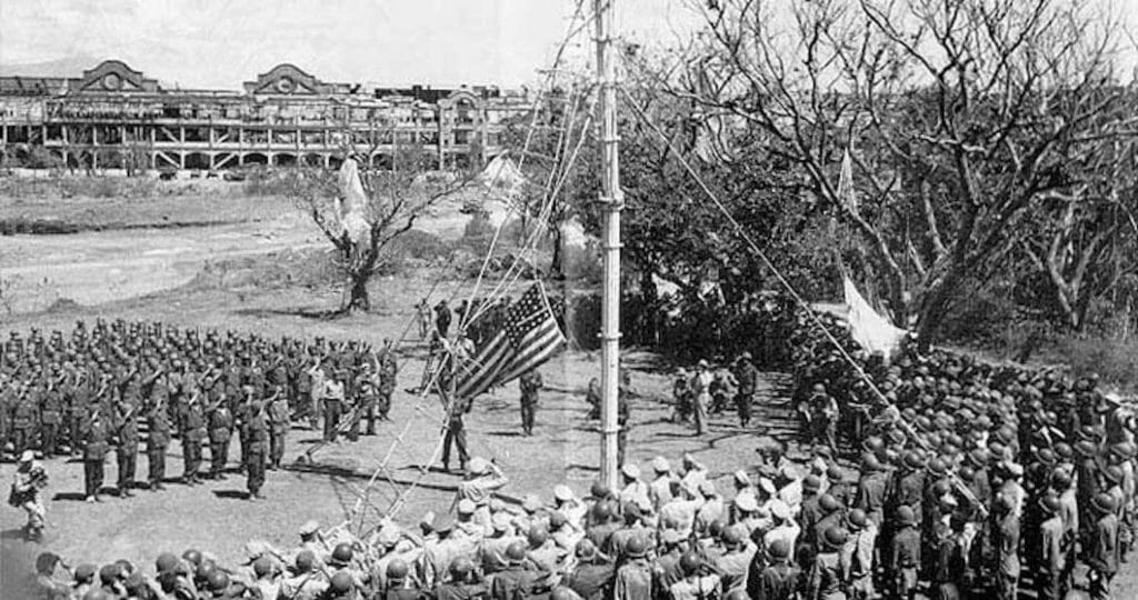 American G.I.s at flag-raising in recaptured Corregidor. Thousands of them mutinied in 1946, demanding repatriation. 