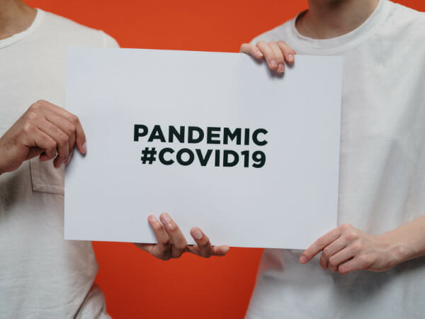 This is a signboard that says "PANDEMIC #COVID19".