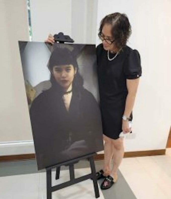 Sally Jonson with portrait of her daughter, Bree, whom she doesn't believe committed suicide. FACEBOOK
