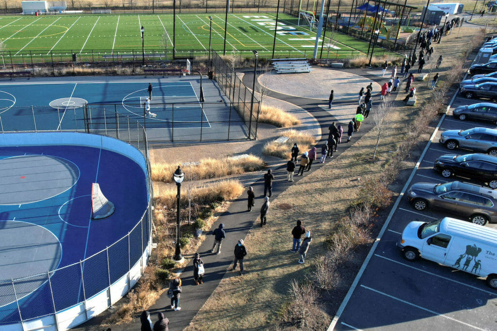 People line up in cold winter temperatures to be tested for the coronavirus disease (COVID-19) in Everett, Massachusetts, U.S., January 4, 2022. Picture taken with a drone. REUTERS/Brian Snyder