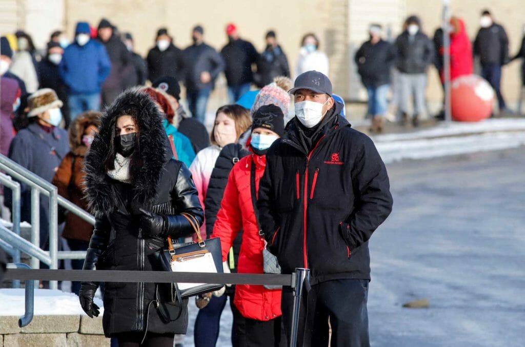 People queue to collect coronavirus disease (COVID-19) antigen test kits at the Hazeldean Mall in Ottawa, Ontario, Canada January 7, 2022. REUTERS/Patrick Doyle
