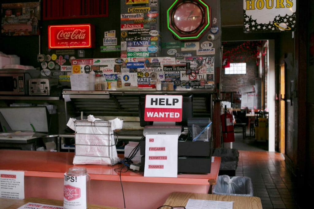 A hiring sign is seen at the register of Burger Boy restaurant, as many restaurant businesses face staffing shortages in Louisville, Kentucky, U.S., June 7, 2021. Picture taken June 7, 2021. REUTERS/Amira Karaoud/File Photo