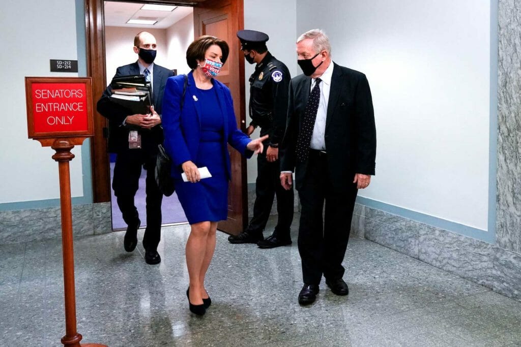 Senators Amy Klobuchar (D-MN) and Dick Durbin (D-IL)depart a Senate Judiciary Committee hearing in Washington, U.S. October 12, 2020. REUTERS/Erin Scott/File Photo