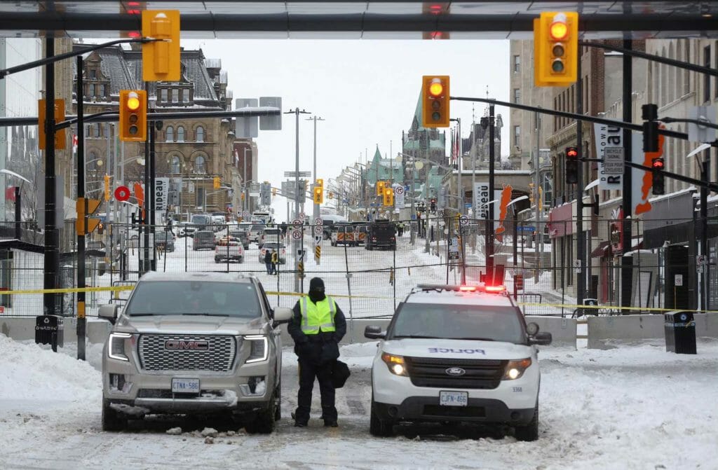 A Canadian police officer stands guard, as police work to evict the last of the trucks and supporters occupying the downtown core, three weeks after a protest against coronavirus disease (COVID-19) vaccine mandates began, near Parliament Hill in Ottawa, Ontario, Canada, February 20, 2022. REUTERS/Lars Hagberg