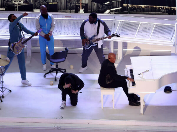 Eminem kneels at the hip hop halftime show of Super Bowl