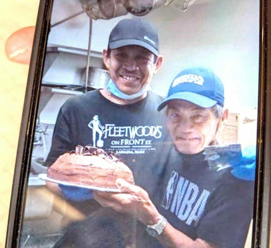 Agustin Dela Cruz (right) celebrating his 73rd birthday with co-workers at Fleetwood’s on Front Street last year. He was killed after a hit-and-run driver him from behind while he was riding his bicycle home from work on Saturday night, Jan. 29. CONTRIBUTED