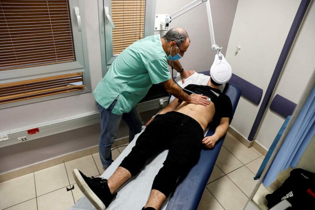 A patient suffering from Long COVID is examined in the post-coronavirus disease (COVID-19) clinic of Ichilov Hospital in Tel Aviv, Israel, February 21, 2022. REUTERS/Amir Cohen