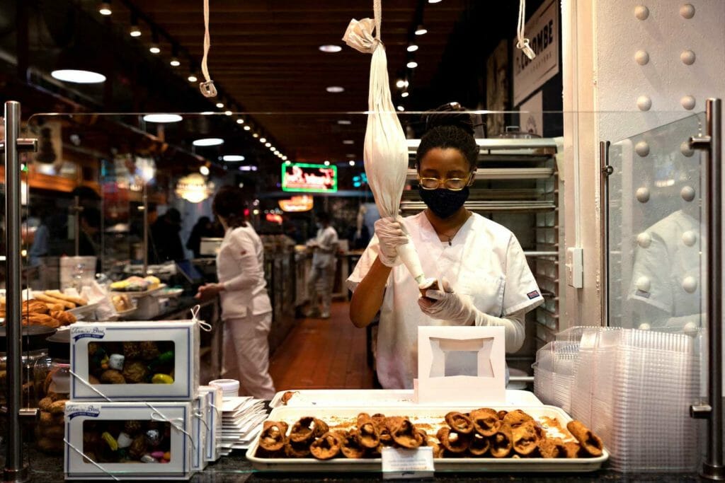  A worker fills a cannoli at a bakery at Reading Terminal Market after the inflation rate hit a 40-year high in January, in Philadelphia, Pennsylvania, U.S. February 19, 2022. REUTERS/Hannah Beier