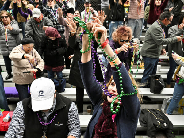 Emerging from a darkness: Mardi Gras attendees drop pandemic woes