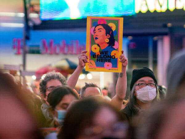 A protester holds up an image during a rally against anti-Asian hate