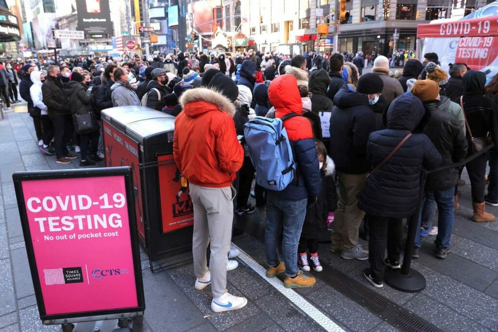 People queue for a COVID-19 test in Times Square as the Omicron coronavirus variant continues to spread in Manhattan, New York City, U.S., December 26, 2021. REUTERS/Andrew Kelly