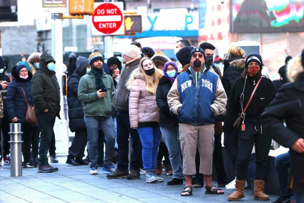 People queue for a COVID-19 test in Times Square as the Omicron coronavirus variant continues to spread in Manhattan, New York City, U.S., December 26, 2021. REUTERS/Andrew Kelly