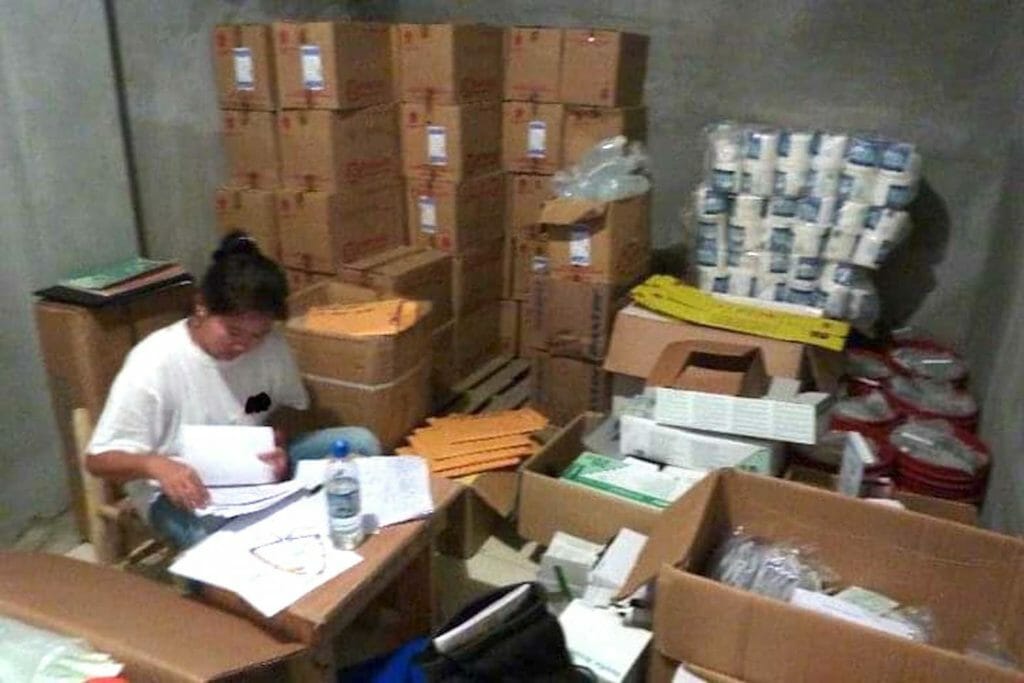 Dr. Jade Pena amid paper work and supplies in Haiti. CONTRIBUTED