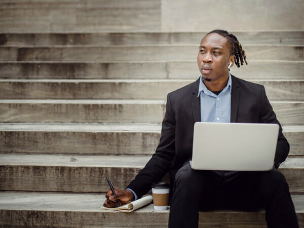 This is an office worker sitting on a concrete stairway.