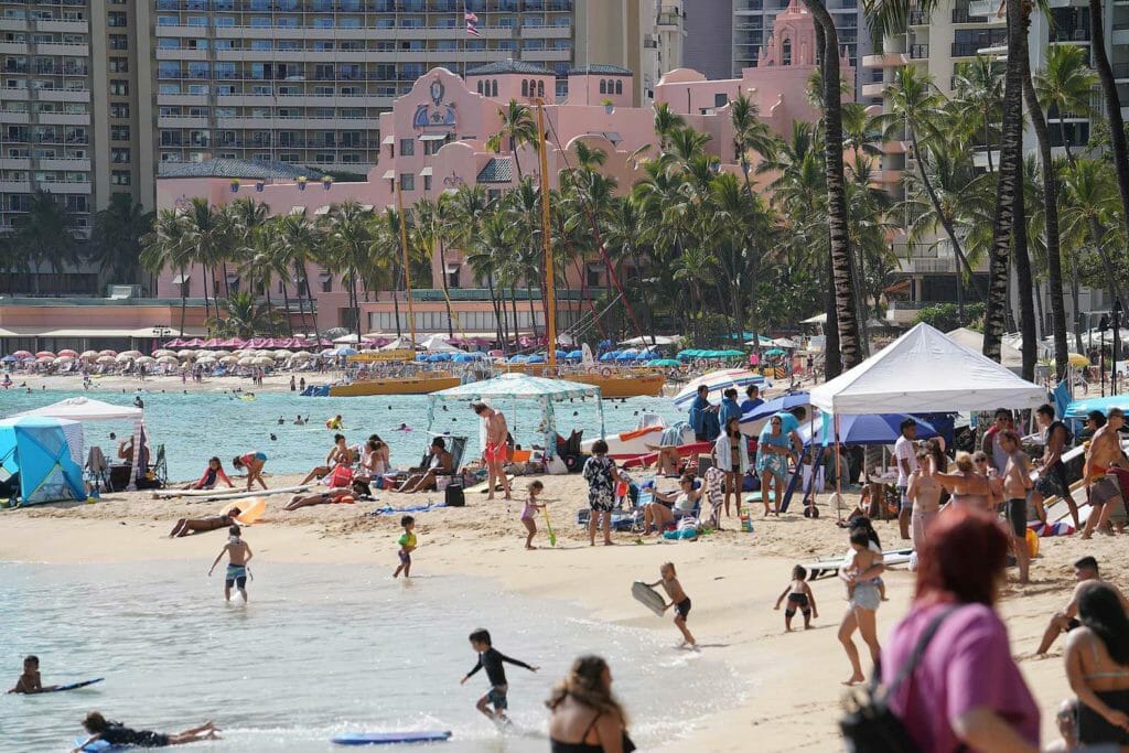 Tourists on Honolulu beach. BROCHURE