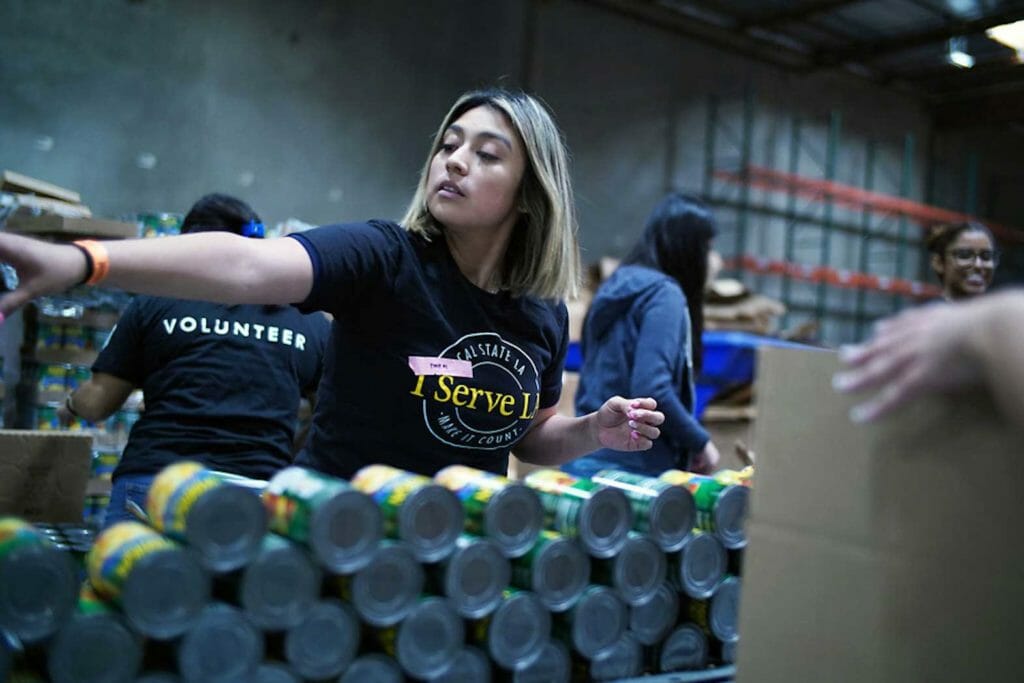 Cal State LA student volunteers help pack food boxes at the Los Angeles Regional Food Bank in Commerce, CA. (Photo: J. Emilio Flores/ Cal State LA)