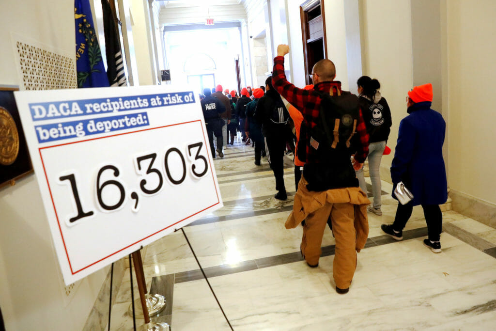Demonstrators calling for new protections for so-called "Dreamers," undocumented children brought to the U.S. by their immigrant parents, walk through a Senate office building on Capitol Hill in Washington, U.S. January 17, 2018. REUTERS/Jonathan Ernst/File Photo