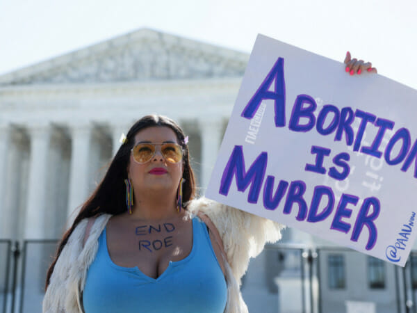 Abortion rights protester chains neck to US Supreme Court fence